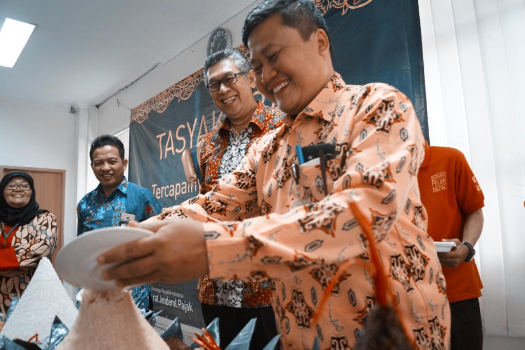 Kepala KPP Karawang Utara, M. Agus Budisantoso memotong tumpeng warna kuning sebagai lambang keberhasilan dan rasa syukur atas tercapainya target penerimaan tahun 2017