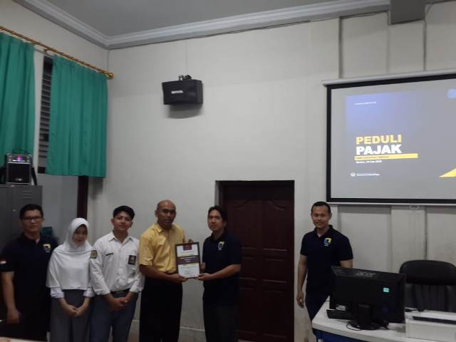 Pemberian piagam dan souvenir kepada perwakilan Sekolah SMAN Harapan I Medan oleh Kepala Seksi Ekstensifikasi dan Penyuluhan.